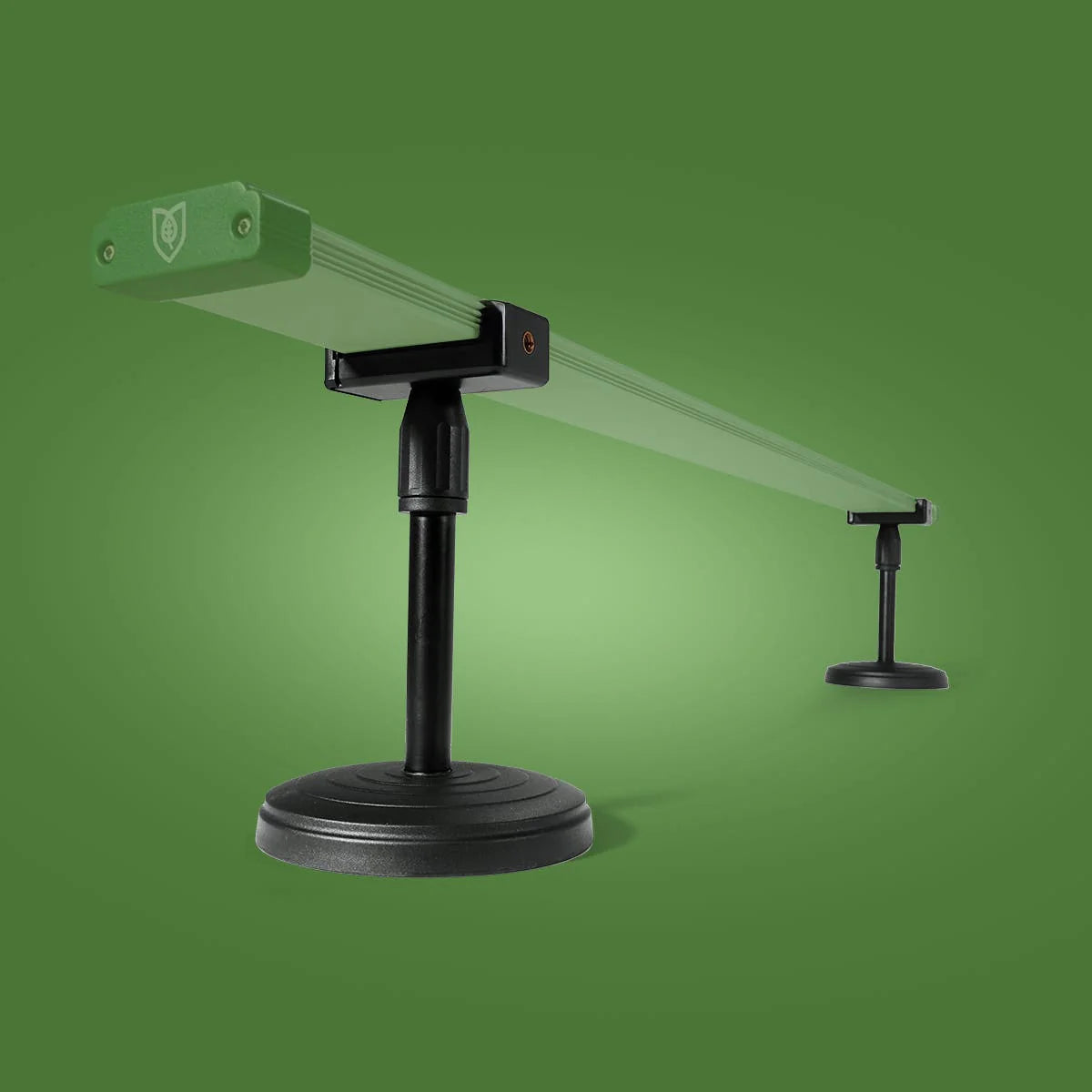 Black stand with green platform on a green background